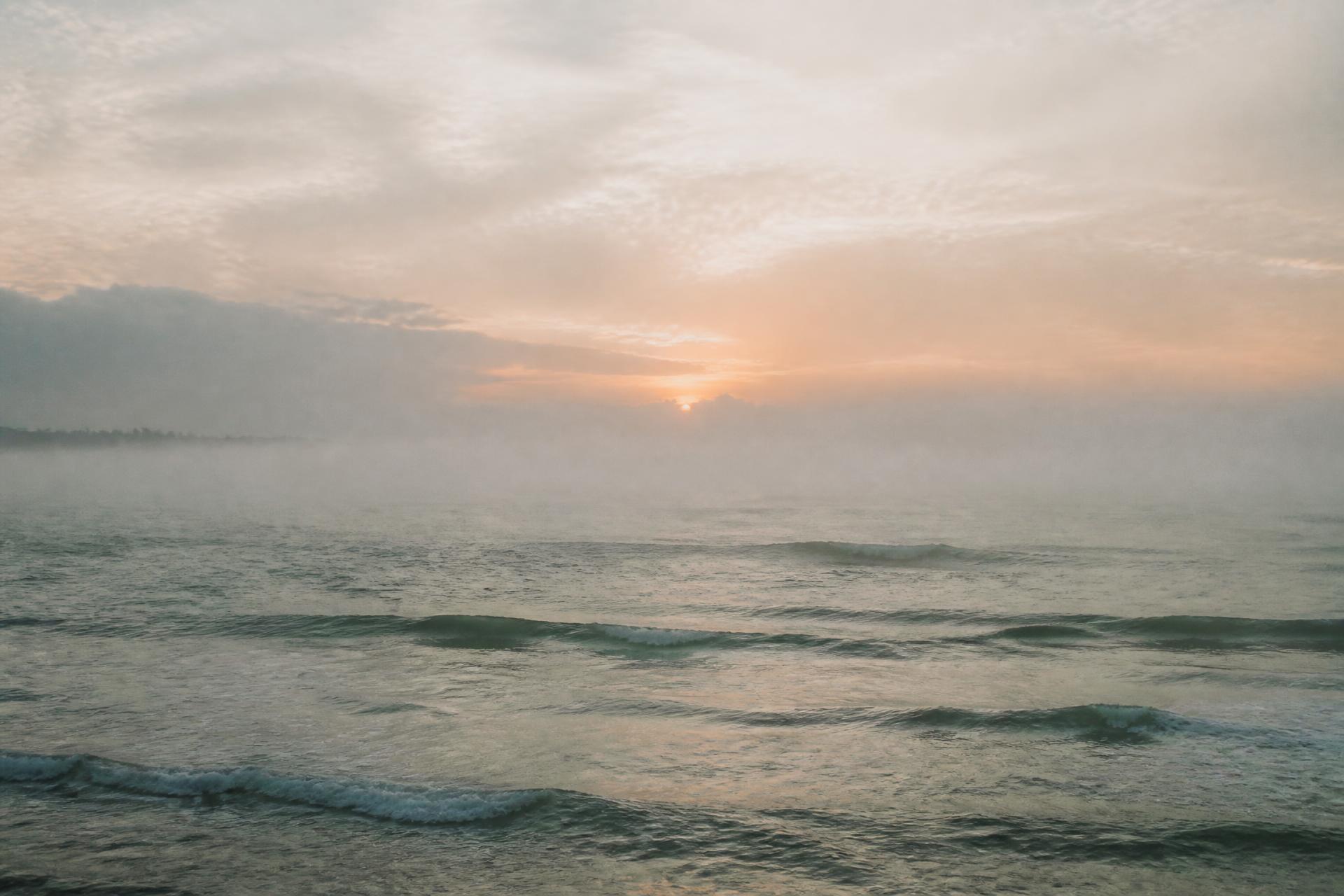 A quiet ocean horizon at soft sunrise
